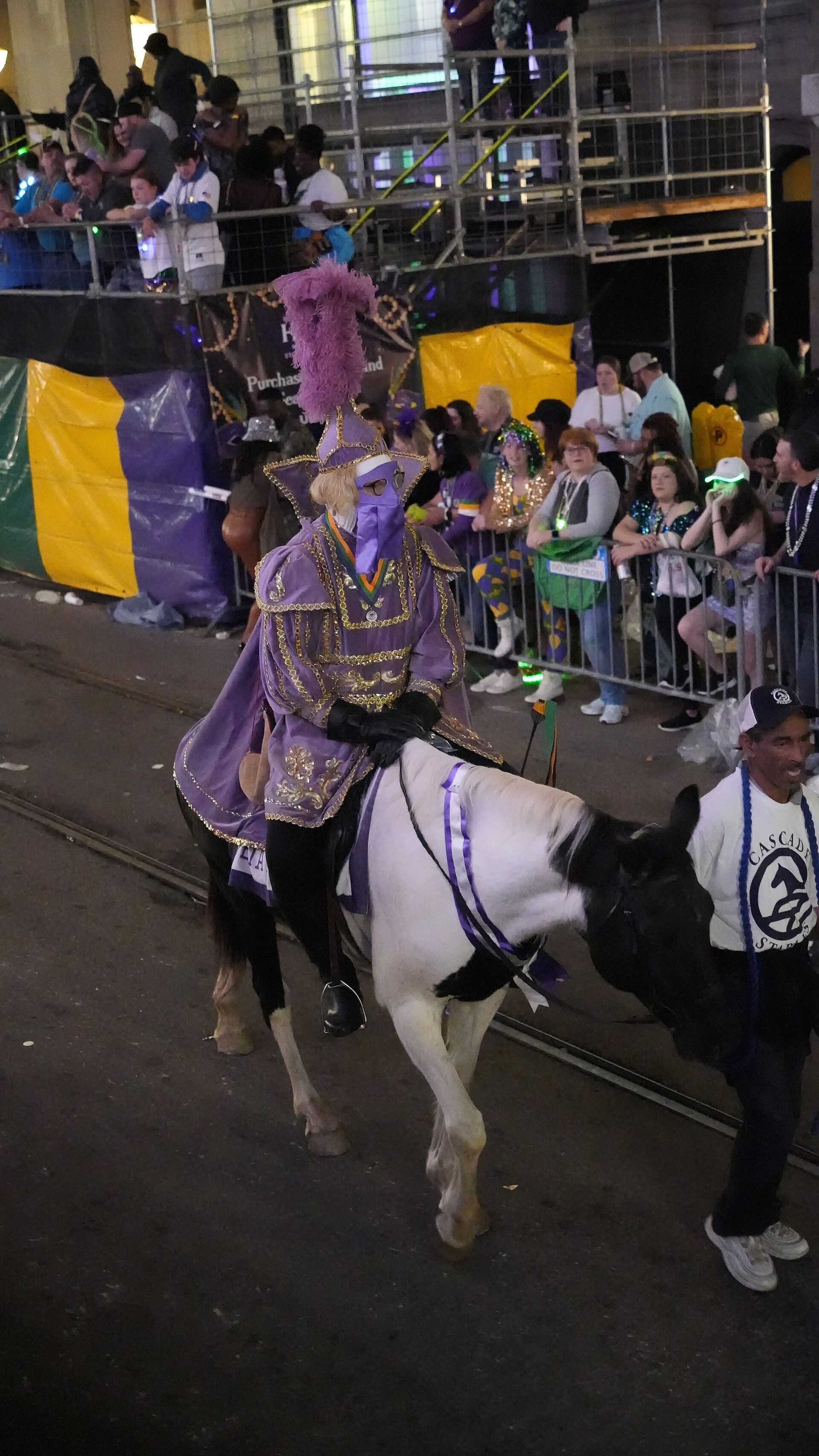 Mardi Gras parade float in New Orleans with costumed riders throwing beads to crowds