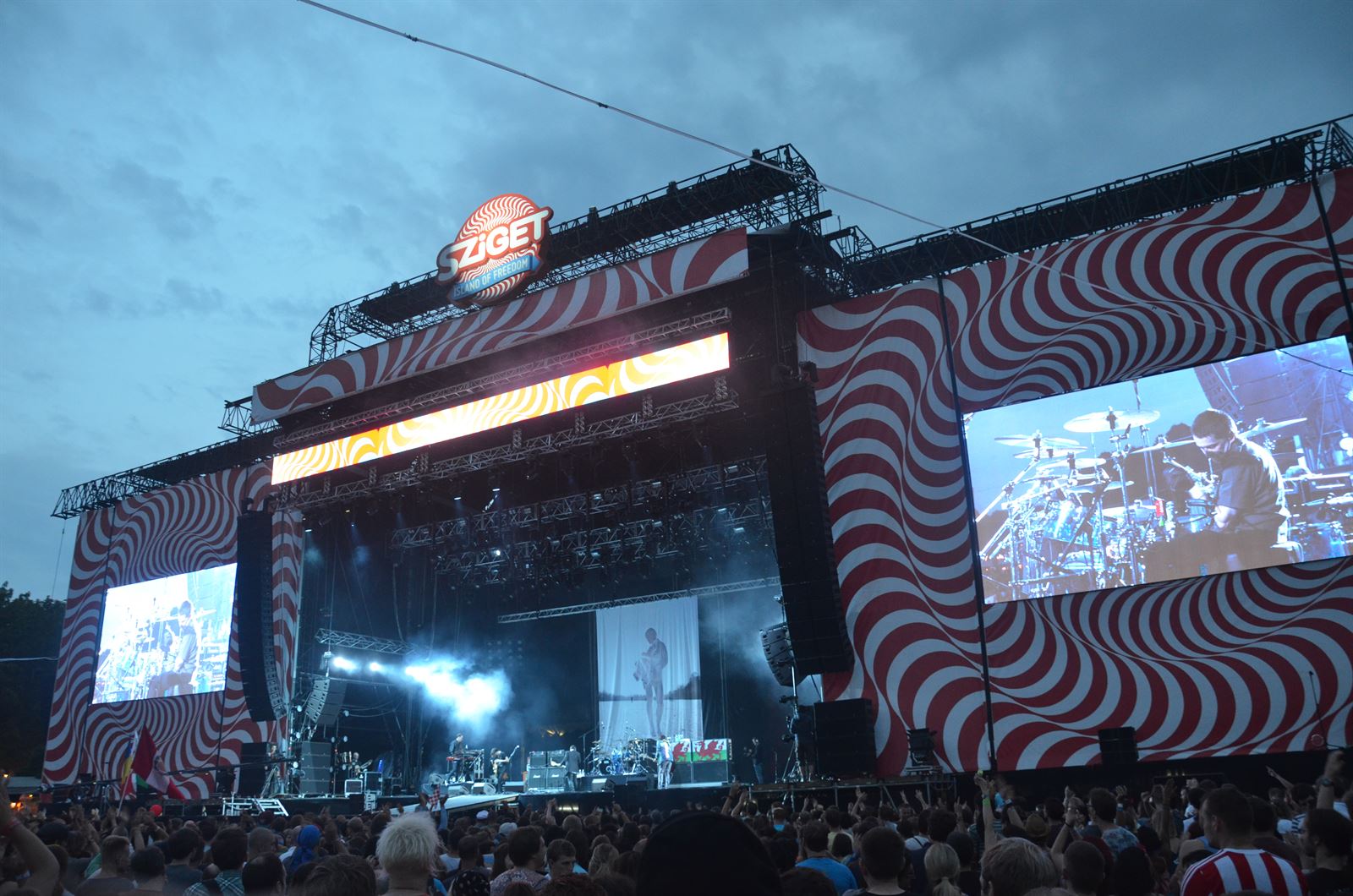A large crowd on Obuda Island at the Sziget Festival in Budapest, hands in the air in front of the main stage